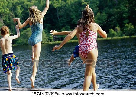 Stock Image - Group of children jumping into water. Fotosearch