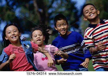 Group of children running on a lawn View Large Photo Image Picture - Group of children running on a lawn. Fotosearch
