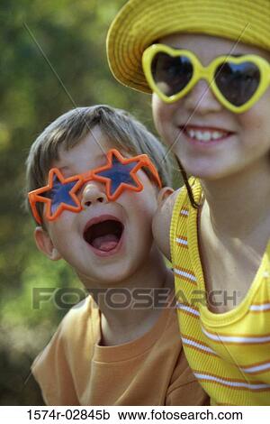 Stock Image - Portrait of a boy and a girl in an amusement park. Fotosearch