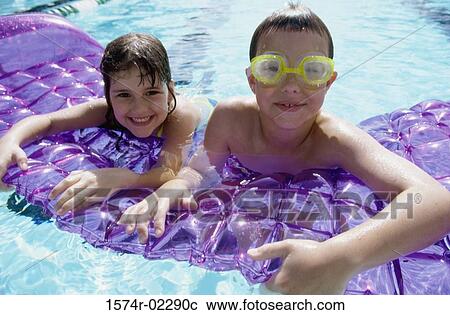Portrait of a boy and a girl leaning on a pool raft View Large Photo Image Stock Image - Portrait of a boy and a girl leaning on a pool raft. Fotosearch
