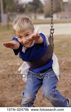 Portrait of a boy hanging on a swing View Large Photo Image Stock Image - Portrait of a boy hanging on a swing. Fotosearch