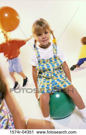 Portrait of a girl sitting on a rubber ball View Large Photo Image Stock Image - Portrait of a girl sitting on a rubber ball. Fotosearch