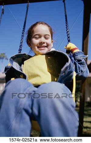 Portrait of a girl sitting on a swing View Large Photo Image Stock Image - Portrait of a girl sitting on a swing. Fotosearch