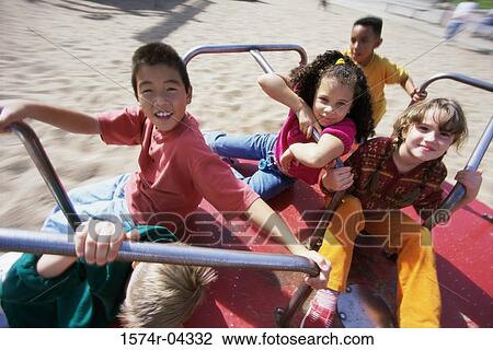 Portrait of a group of children sitting on a merry-go-round View Large Photo Image Stock Image - Portrait of a group of children sitting on a merry-go-round. Fotosearch