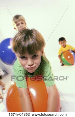 Portrait of three boys playing with rubber balls View Large Photo Image Stock Image - Portrait of three boys playing with rubber balls. Fotosearch
