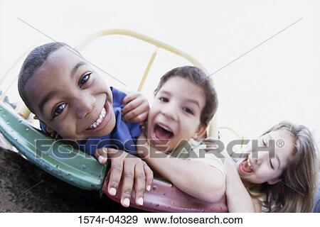 Portrait of two boys and a girl playing View Large Photo Image Stock Photo - Portrait of two boys and a girl playing. Fotosearch