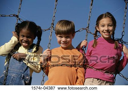 Portrait of two girls and a boy on a jungle gym View Large Photo Image Stock Photo - Portrait of two girls and a boy on a jungle gym. Fotosearch