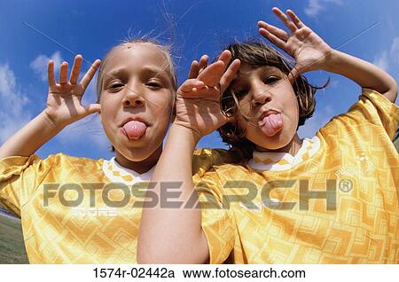 Portrait of two girls making faces View Large Photo Image Stock Image - Portrait of two girls making faces. Fotosearch
