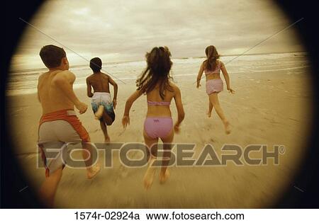 Rear view of a group of children running on the beach View Large Photo Image Stock Image - Rear view of a group of children running on the beach. Fotosearch
