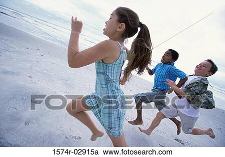 Side profile of a girl and two boys running on the beach View Large Photo Image Stock Image - Side profile of a girl and two boys running on the beach. Fotosearch