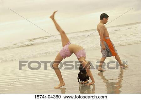 Side profile of a girl bending over backwards and a boy walking behind her View Large Photo Image Stock Image - Side profile of a girl bending over backwards and a boy walking behind her. Fotosearch
