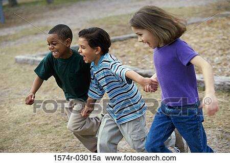 Side profile of two boys and a girl running holding hands View Large Photo Image Stock Image - Side profile of two boys and a girl running holding hands. Fotosearch