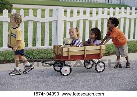 Side profile of two boys and two girls playing with a push cart View Large Photo Image Stock Image - Side profile of two boys and two girls playing with a push cart. Fotosearch