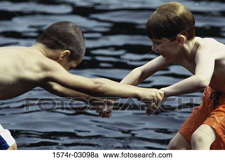 Side profile of two boys playing in the water View Large Photo Image Stock Image - Side profile of two boys playing in the water. Fotosearch