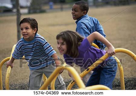 Two boys and a girl on a merry-go-round View Large Photo Image Stock Photo - Two boys and a girl on a merry-go-round. Fotosearch