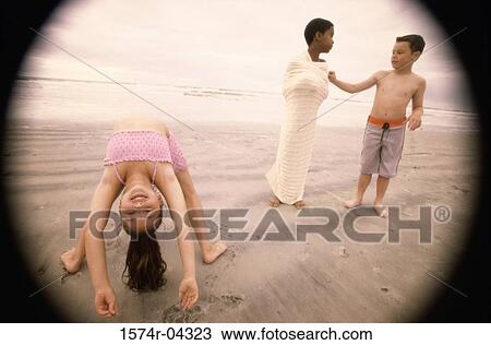 Two boys and a girl on the beach View Large Photo Image Stock Image - Two boys and a girl on the beach. Fotosearch