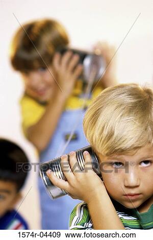 Two boys playing with tin can phone View Large Photo Image Stock Photo - Two boys playing with tin can phone. Fotosearch