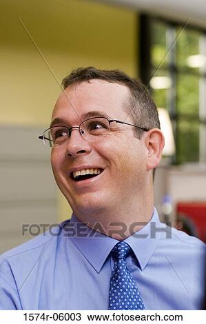 Close-up of a businessman laughing in an office View Large Photo Image Stock Image - Close-up of a businessman laughing in an office. Fotosearch