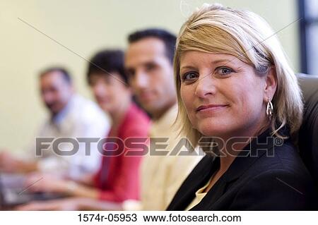 Group of business executives sitting in a conference room View Large Photo Image Stock Image - Group of business executives sitting in a conference room. Fotosearch