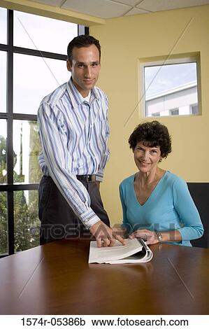 Portrait of a businessman and a businesswoman in a conference room View Large Photo Image Stock Image - Portrait of a businessman and a businesswoman in a conference room. Fotosearch