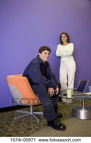 Stock Image - Portrait of a businessman and a businesswoman smiling. Fotosearch