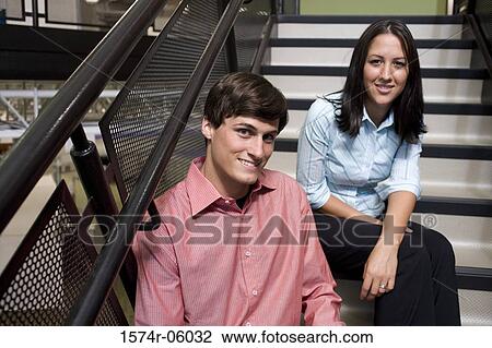 Portrait of a businessman and a businesswoman sitting on stairs View Large Photo Image Stock Image - Portrait of a businessman and a businesswoman sitting on stairs. Fotosearch