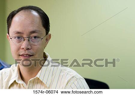 Picture - Portrait of a businessman in an office. Fotosearch