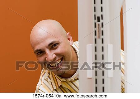 Portrait of a businessman peeking from behind a wall View Large Photo Image Stock Image - Portrait of a businessman peeking from behind a wall. Fotosearch