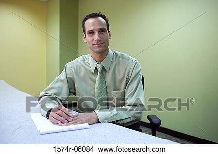 Picture - Portrait of a businessman sitting in an office. Fotosearch