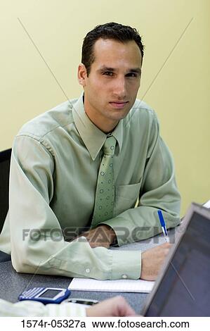 Portrait of a businessman sitting in an office View Large Photo Image Stock Image - Portrait of a businessman sitting in an office. Fotosearch