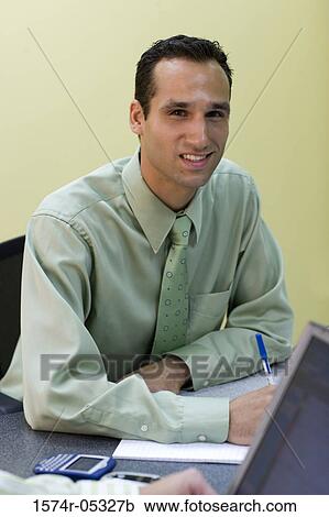 Portrait of a businessman sitting in an office View Large Photo Image Stock Image - Portrait of a businessman sitting in an office. Fotosearch
