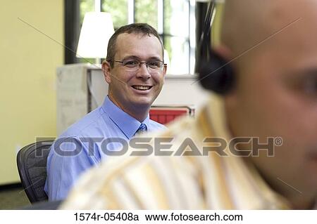 Portrait of a businessman sitting in an office View Large Photo Image Stock Image - Portrait of a businessman sitting in an office. Fotosearch
