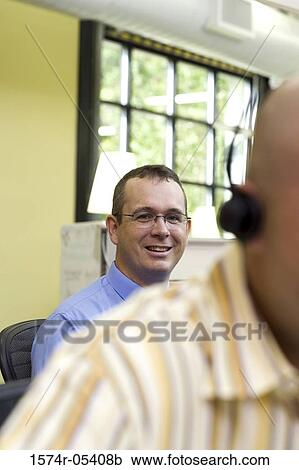 Portrait of a businessman sitting in an office View Large Photo Image Stock Image - Portrait of a businessman sitting in an office. Fotosearch