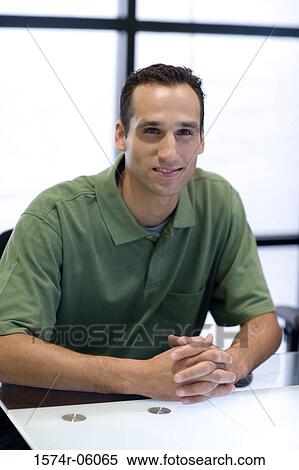 Stock Photography - Portrait of a businessman sitting in an office. Fotosearch