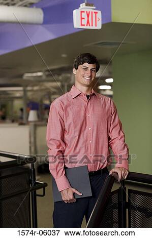 Stock Photo - Portrait of a businessman standing in an office. Fotosearch