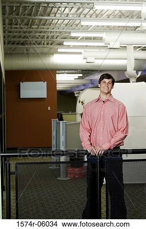Portrait of a businessman standing against a railing View Large Photo Image Picture - Portrait of a businessman standing against a railing. Fotosearch