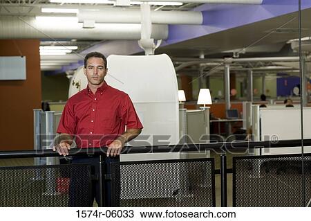 Portrait of a businessman standing against a railing View Large Photo Image Stock Image - Portrait of a businessman standing against a railing. Fotosearch