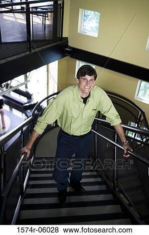 Stock Photo - Portrait of a businessman walking up stairs. Fotosearch