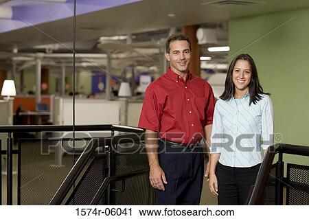Portrait of a businesswoman and a businessman standing on stairs View Large Photo Image Stock Image - Portrait of a businesswoman and a businessman standing on stairs. Fotosearch