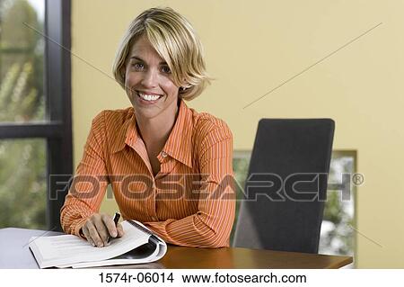 Picture - Portrait of a businesswoman sitting in an office. Fotosearch