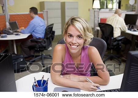 Stock Image - Portrait of a businesswoman sitting in an office. Fotosearch