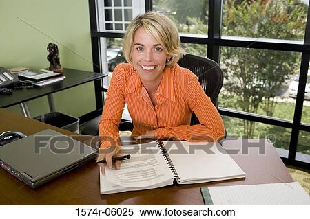 Stock Photography - Portrait of a businesswoman sitting in an office. Fotosearch