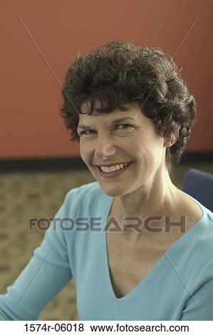 Portrait of a businesswoman smiling in an office View Large Photo Image Stock Photo - Portrait of a businesswoman smiling in an office. Fotosearch