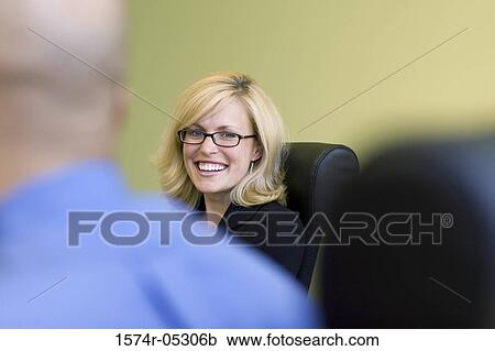 Stock Image - Portrait of a businesswoman smiling. Fotosearch