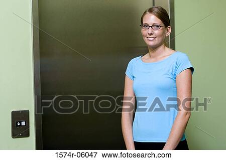 Portrait of a businesswoman standing near an elevator View Large Photo Image Stock Photo - Portrait of a businesswoman standing near an elevator. Fotosearch