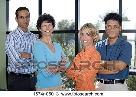 Stock Image - Portrait of a group of business executives standing in an office. Fotosearch