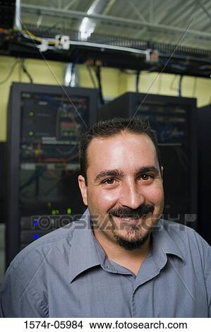 Picture - Portrait of a technician in a server room. Fotosearch