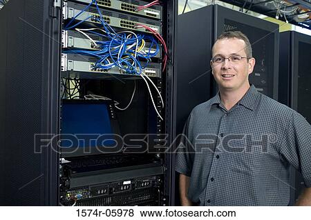 Portrait of a technician standing in a server room View Large Photo Image Stock Photo - Portrait of a technician standing in a server room. Fotosearch