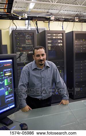 Portrait of a technician standing in a server room View Large Photo Image Stock Photograph - Portrait of a technician standing in a server room. Fotosearch