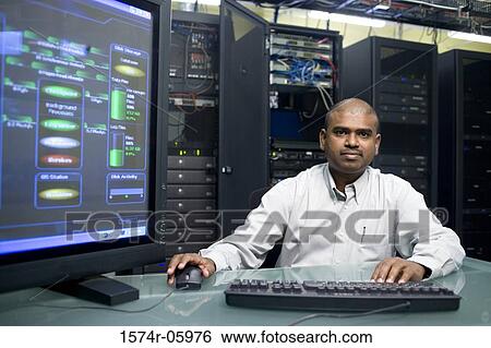 Portrait of a technician working on a computer in a server room View Large Photo Image Stock Photograph - Portrait of a technician working on a computer in a server room. Fotosearch